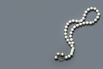Prayer beads on dark grey background. Ramadan celebration
