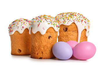 Sweet Easter cakes and painted eggs on white background