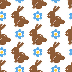Easter seamless pattern with chocolate rabbits and blue flowers on white background. Background with Easter bunnies and daisies. Cute hand drawn background for Easter cards, textile prints, wallpapers