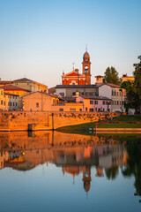 Obraz premium Famous Roman Bridge and historic center of Rimini, Italy at sunset