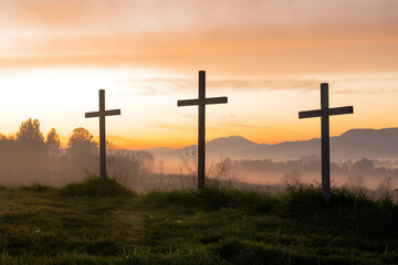 Three Crosses on a Hill at Sunrise Representing Easter, the Resurrection of Jesus Christ, Christian Faith, and Hope – Symbol of Salvation, Forgiveness, and Redemption in a Scenic Religious Landscape