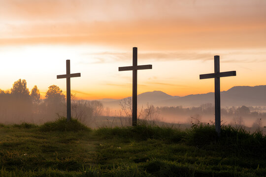 Three Crosses on a Hill at Sunrise Representing Easter, the Resurrection of Jesus Christ, Christian Faith, and Hope &ndash; Symbol of Salvation, Forgiveness, and Redemption in a Scenic Religious Landscape