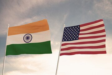 Relations between the countries of the United States of America USA and India represented by the concept of two flags waving against a cloudy sky.3d render.