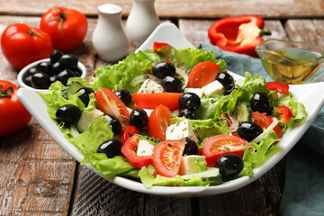 Delicious fresh Greek salad on wooden table, closeup