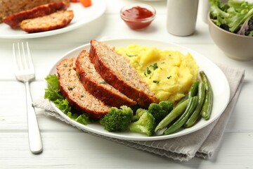 Delicious baked turkey meatloaf with mashed potato served on white wooden table, closeup