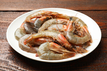 Fresh raw shrimps on wooden table, closeup