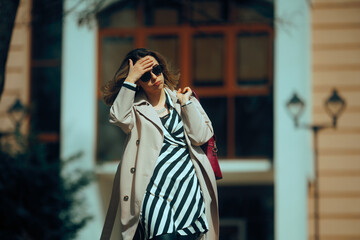 Casual Woman Walking Outdoors Feeling Tired and Stressed Out. Unhappy woman during sunny and windy...