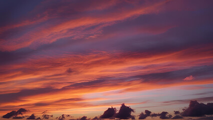 The sky is adorned with a breathtaking sunset, casting its glow over the clouds