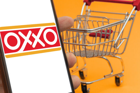Miniature shopping cart next to OXXO logo, reference in convenience stores. Mexican supermarket chain with international locations
