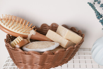 Natural bathing essentials arranged in a woven basket on a shelf