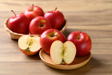 Red apple fruit (Gala apple) on wooden plate with wooden background