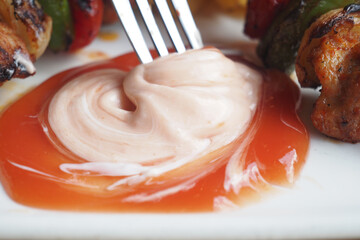 Dip made of sauce and mayonnaise served with grilled skewers