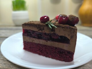 pie with cherries on top and jam inside on a plate. High-quality photo