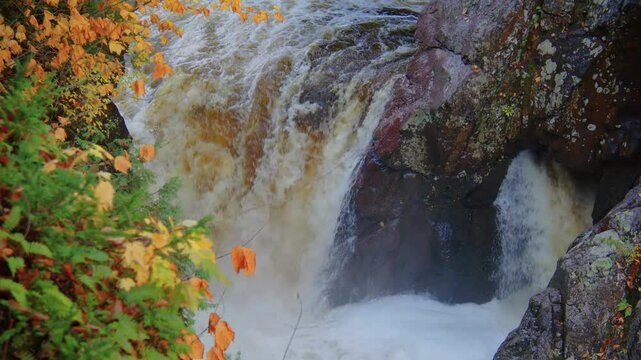 Experience the rich fall colors and peaceful landscape of High Falls Gorge in the Adirondacks. This 4K footage captures the beauty of the autumn season with the river creek flowing through.