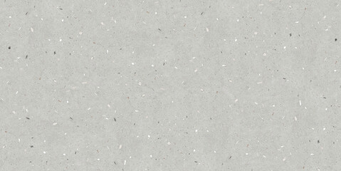 A gray terrazzo surface with subtle white and dark specks, resembling a fine cement texture.