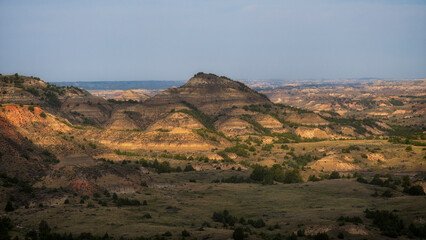 An expansive view of layered hills and mountains captivates with its unique geological features and...
