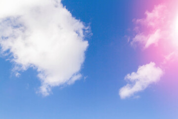 White airy beautiful clouds in a bright blue sky. Clear sunny weather. The concept of environmental safety and cleanliness..