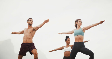 Yoga, warrior pose and people in nature for wellness, balance and health outdoors in morning. Fitness, pilates and man and women for exercise, workout and stretching for calm, mobility or flexibility