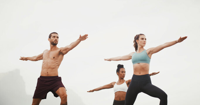 Yoga, warrior pose and people in nature for wellness, balance and health outdoors in morning. Fitness, pilates and man and women for exercise, workout and stretching for calm, mobility or flexibility