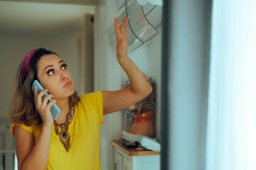 Woman with Broken Air Conditioning Calling the Repair Service. Unhappy customer having ac problems...