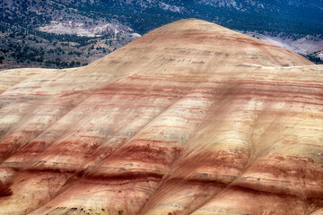 A vibrant close-up of the rich, multicolored patterns on the Painted Hills, showcasing the intricate layers of nature's artistry in a stunning display of color and texture.