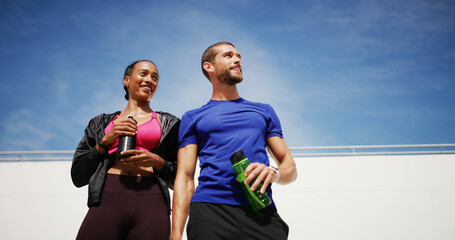 Outdoor, thinking and couple with fitness, water bottle and confidence with break, wellness and challenge. People, man and woman in city, exercise and training with workout, hobby or space with sky
