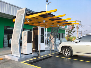 EVAT or Electric vehicle charging station installed in front of convenience store in local area of Asian countries.