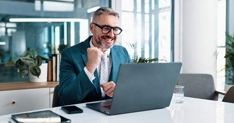 Laptop, businessman and excited with fist pump in office, celebration and settlement for corporate case. Career, mature person and lawyer with success for justice, legal work and victory for law firm