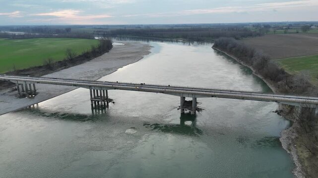 Slow motion drone capture of the Verdi Bridge over the Po River, connecting Seniga in Parma province with San Daniele Po in Cremona, highlighting Northern Italy's scenic beauty