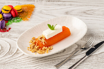 Pumpkin dessert with tahini and walnuts on a porcelain plate