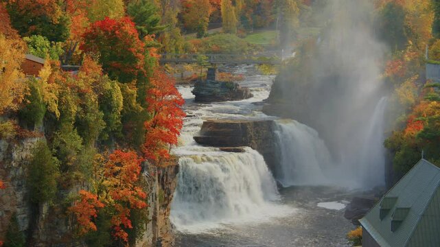 Beautiful footage of the Ausable Chasm waterfall in the Adirondacks, with fall leaves and vibrant autumn colors surrounding the landscape for a breathtaking scene.