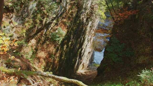 A beautiful shot of the Ausable Chasm waterfall surrounded by rich autumn foliage, offering a peaceful and awe-inspiring view of the Adirondacks in full fall glory.
