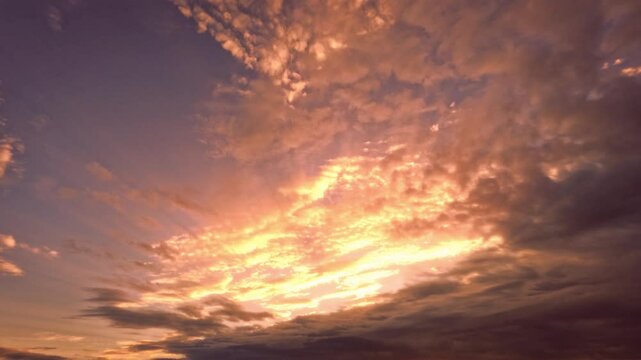 timelapse - gold sunset scene with light clouds - loop video