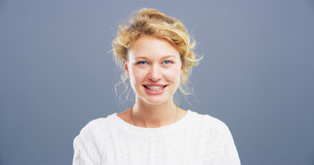 Portrait, smile and space with student woman in studio for college, school or university study. Confident, education and mockup with German person on gray background for development or learning