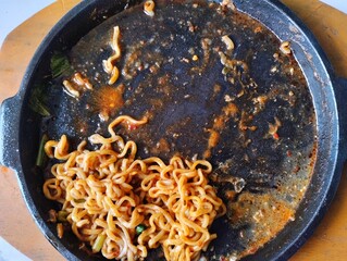 Empty Sizzling Plate with Remnants of Noodles