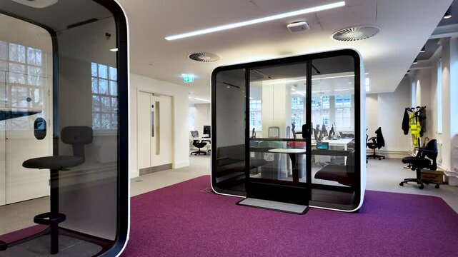 Comfortable soundproof office pods guaranteeing privacy and concentration in a modern open space office