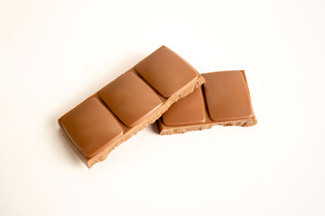 Milk chocolate flat lay, top view on white background.