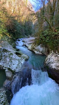 Waterfall in the picturesque Chernigov gorge in the mountains of the Caucasus. A mountain park in the Chernigov gorge with the Malaya Machara River, Abkhazia. Chernigovka