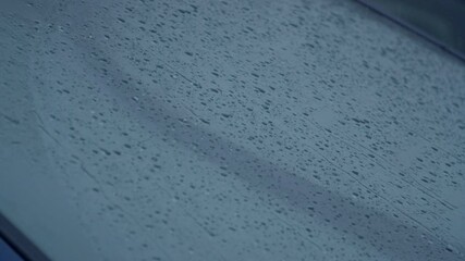 Slow Motion Rain Drop Beads Rolling Down a Windsheild