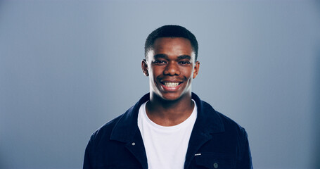Obraz premium Portrait, space and student with black man in studio for development, education or learning. College, scholarship or university with confident person on gray background mockup for academic curriculum