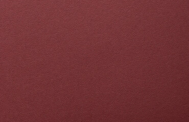 Burgundy paper background with a matte texture and fine, tactile surface. Deep, rich red tones...