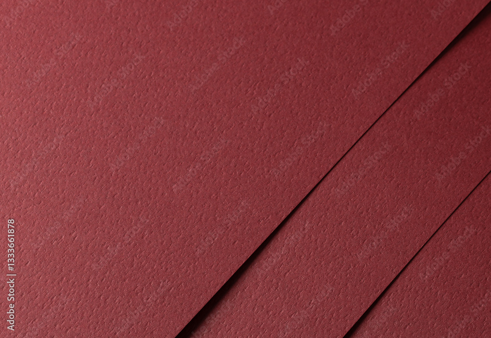 Poster deep burgundy paper background with a matte texture and fine, tactile surface. warm red tones create