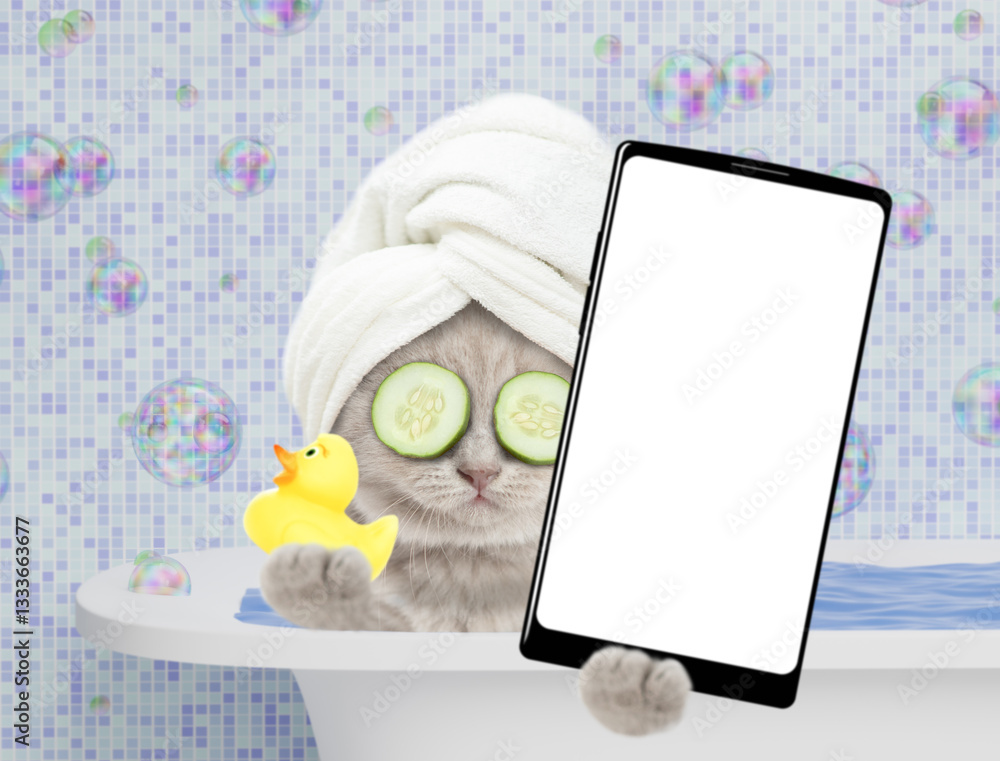 Aufkleber cute kitten with towel on it head takes the bath at home and shows big smartphone with white blank s