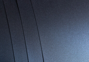 Navy blue paper background with a glossy, pearlescent texture and a shimmering effect. Deep, rich...