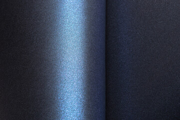 Navy blue paper background with a glossy, pearlescent texture and a shimmering effect. Deep,...