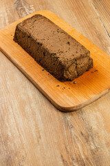 Homemade chicken liver pate served on a wooden cutting board