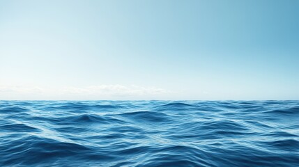 Obraz premium Gentle ocean waves ripple beneath a calm, clear sky, creating a serene and tranquil seascape.