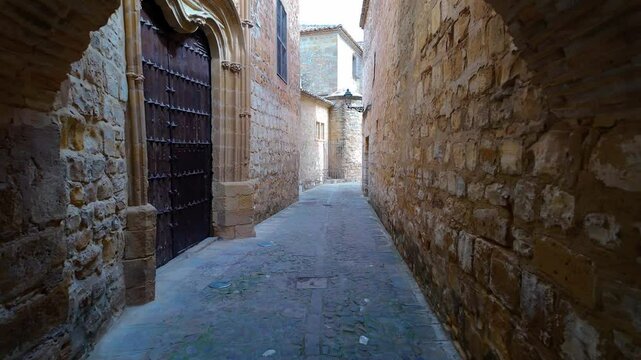 Stone arch in the picturesque narrow streets of the medieval town of Baeza, Andalusia.