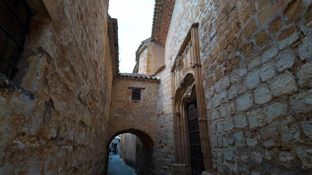 Impressive medieval houses with large wooden doors and piece ornaments on the facades, Baeza.