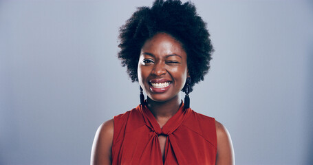 Black woman, happy and face with wink in studio portrait, sign or emoji for secret, flirt or joke...